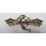 A yellow metal Art Deco brooch marked 750 set diamonds, rubies and drop pearl 8.3g