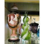 A decorative glass lidded vase with scene of Victorian lady, a green and white swirl pattern vase