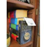 Six Harry Potter hardback books and a paperback