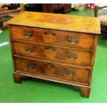 A late 18th Century walnut chest of three drawers with brass handles