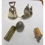 A galleon clock, bell, fox head bottle stopper, egg shaped lidded container and a military lighter