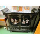An Oriental black lacquer cabinet, decorated geisha, birds and flowers