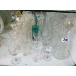 Three cut glass decanters and assorted drinking glasses