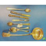 A silver ladle spoon and other silver flatware