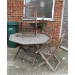 A teak table and six chairs