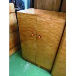 An Art Deco walnut ladies and gent's wardrobes, two bedsides and headboard with amber style