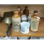 Some stoneware ginger beer bottles and a brass scoop