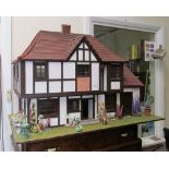 A Tudor style dolls house with fitted furniture