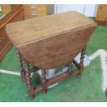 An oak gateleg table on barleytwist legs