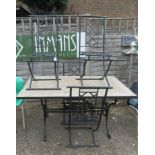 A tile top and wrought iron garden table and four chairs