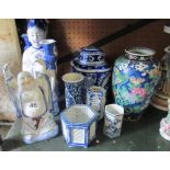 A blue and white buddha and pair of oriental figures with candleholder and other blue and white