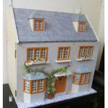 A Georgian style dolls house with front door and fitted furniture