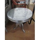 Two silver coloured pillar and tripod tables