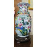 An oriental vase on wooden base (hole as lamp)