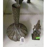 An Islamic copper vase and a seated deity