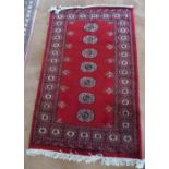 A Bokhara red ground rug