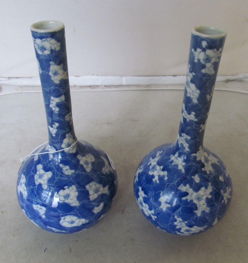 A pair of blue and white long necked vases floral design - Image 2 of 3