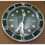 A Rolex style battery operated wall clock with green face and dial