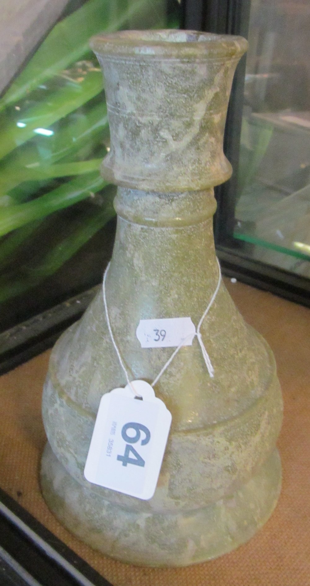 An Islamic green stone bottle