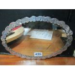 A white metal mirror with embossed decorative back marked 800