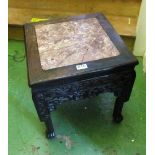 An oriental marble top table