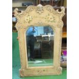 A large decorative mirror with flower and cherub head detail