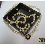 A pearl necklace with garnet and pearl clasp and some pearls in need of re-stringing