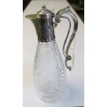 A glass claret jug etched vine leaf design with plated lid and handle, the handle with mechanism for