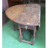 A 19th Century oak dropleaf table with drawer on turned supports