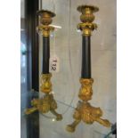 A pair of Regency style candlesticks gilt tops and bases with claw feet