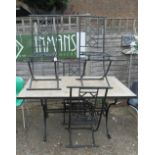 A tile top and wrought iron garden table and four chairs