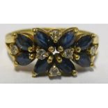 A gold coloured ring set sapphires and diamonds marked 18k 4.3g, size M