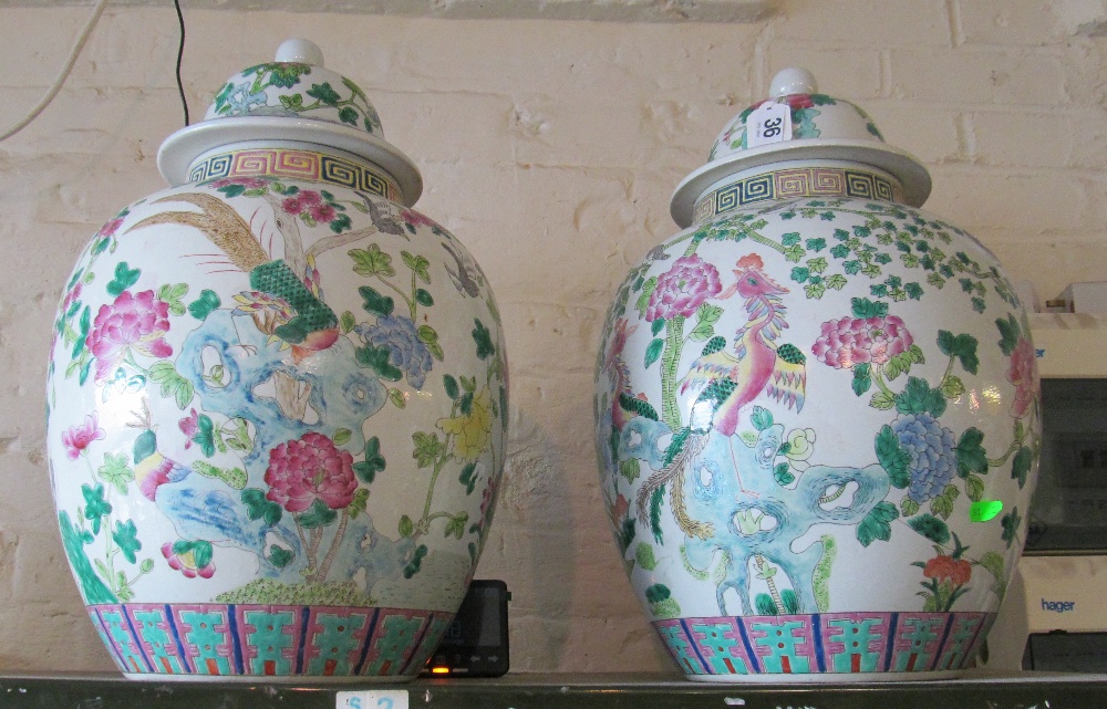 A pair of large famille rose lidded vases