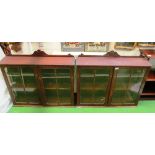 A pair of mahogany glass fronted wall cabinets