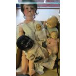 A German porcelain headed doll and some other dolls