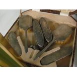 A boxed silver dressing table set (missing mirror), two silver backed brushes and a sovereign