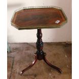 A 19th Century occasional table with brass gallery on pillar and tripod base (water damage to top)