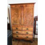 A 19th Century figured mahogany linenpress two cupboard doors (fitted shelves) above two short and