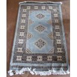 A pale blue Pakistani Ghom rug geometric design