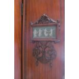 An Edwardian satin walnut mirror door wardrobe with jasperware style panels of dancing figures and