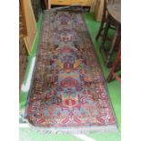 A carpet runner blue ground stylized pattern