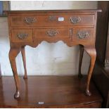 A walnut lowboy with four small drawers on cabriole legs (back leg loose)