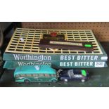 Three Worthington beer trays, a cribbage board, Corgi coach and a BMW