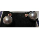 A pair of Tahitian black pearl earrings