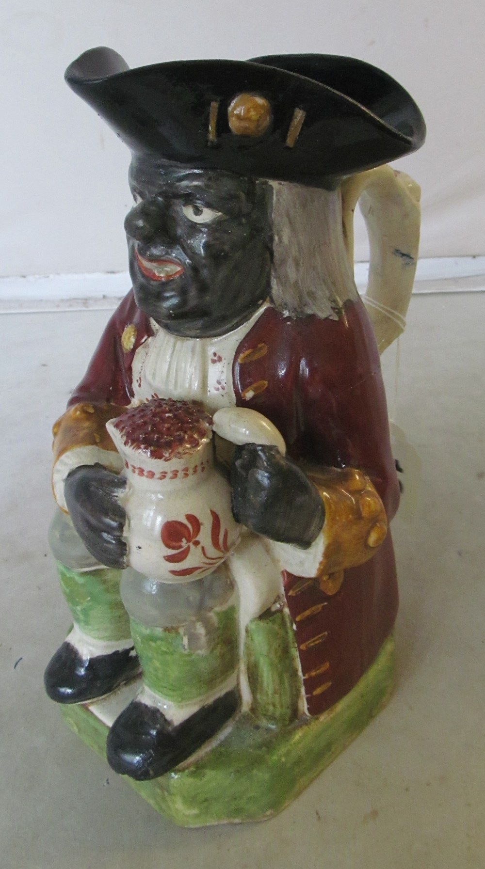 A 19th Century Pratt style 'Black man' toby jug (restored and missing hat lid)