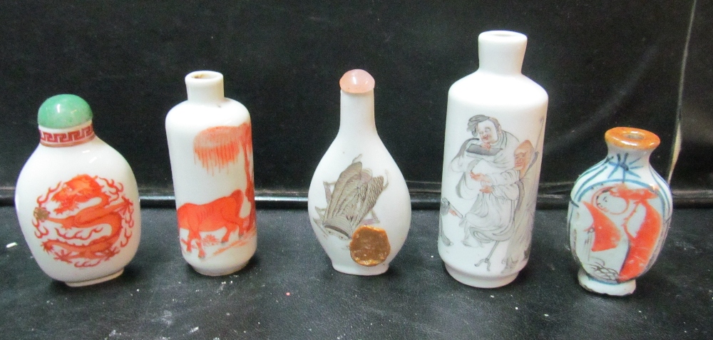 Five oriental scent bottles one with insect (cockroach?) and applied seal, one with figures, a