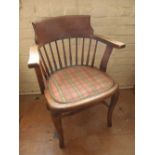 An oak office chair and ladder back chair