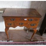 A walnut lowboy with four small drawers on cabriole legs (back leg loose)
