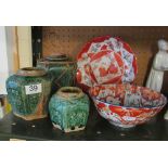 Three green pottery ginger jars (one with stopper) and an Imari bowl and plate