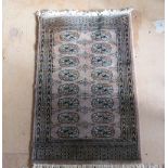 A small Bokhara brown rug (slight tear)